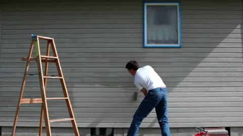 Man Repainting House Wall Stock Footage 11129537