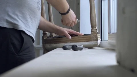 Man repairing chair in the room Stock Footage