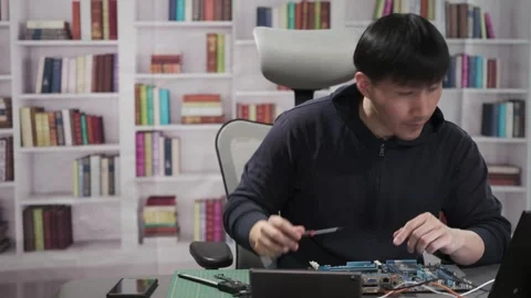 Man repairing a computer circuit board hardware for Artificial Intelligence Stock Footage 295394833