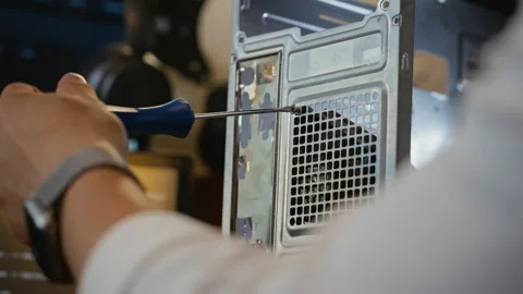 Man Repairing Desktop Computer Case with Screwdriver Stock Footage 338422853