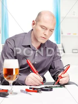 Man repairing an electronic device Stock Photos