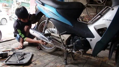 The man is repairing the moto Stock Footage 72968004