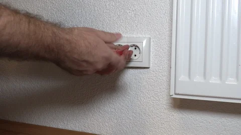 The man is repairing the outlet Stockbeeldmateriaal 95126086