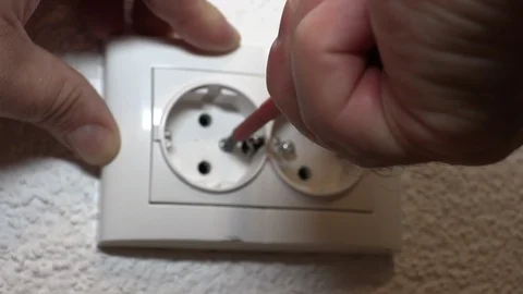 The man is repairing the outlet Видео 95160749