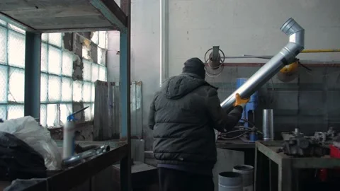 Man Repairing Pipes In Workshop Stock Footage 169347218
