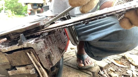 Man Repairing Rusty Chainsaw Blade Stock Footage 326132228