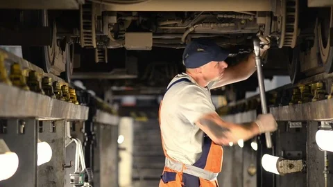 A man repairing a train Stock Footage 76388139
