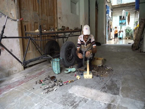 Man repairs a broken ventilator in the studio at Havana street Stock Footage 71035106