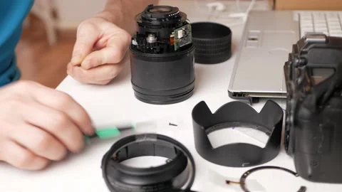 Man repairs camera lens, autofocus motor, tools. destroyed, broken, not working Stock Footage 168375748