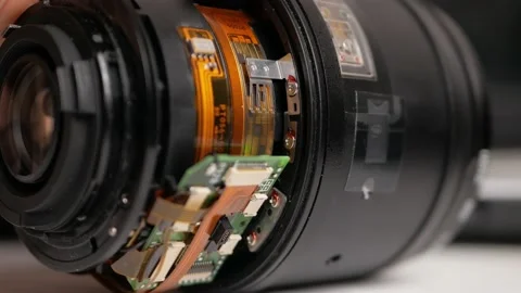Man repairs camera lens, autofocus motor, tools. naked lens Stock Footage 168375831