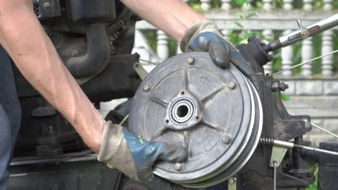 A man repairs a clutch from a tractor Stock Footage 266805014