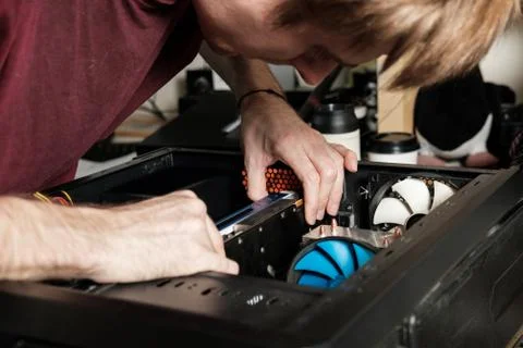 Man repairs a computer system unit, changes parts, video card and hard drive Stock Photos