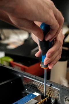 Man repairs a computer system unit, changes parts, video card and hard drive Stock Photos