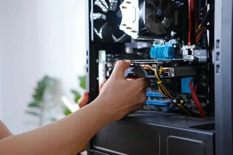 Man repairs a computer system unit, changes parts, video card and hard drive Stock Photos