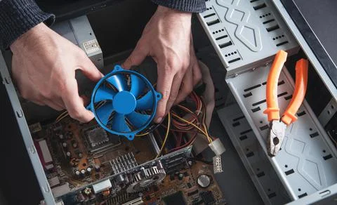Man repairs cooling system of computer. Stock Photos