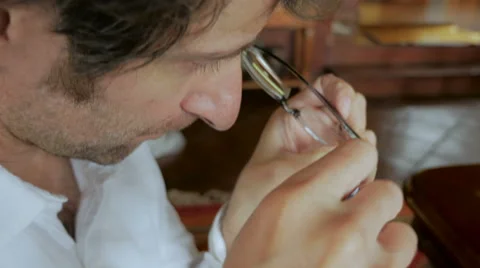 Man repairs glasses with tiny screwdriver - handheld Video stock 65338804