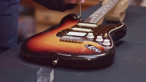 Man repairs guitar with a screwdriver Stock-Footage 102056352