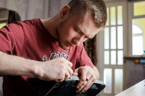 Man repairs laptop by himself, computer repair 스톡 사진