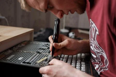 Man repairs laptop by himself, computer repair Stock Photos