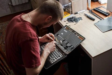 Man repairs laptop by himself, computer repair Stock Photos