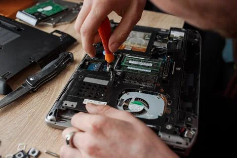 Man repairs laptop by himself, computer repair Stock Photos