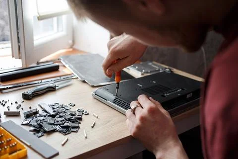 Man repairs laptop by himself, computer repair Stock Photos