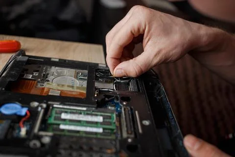 Man repairs laptop by himself, computer repair Stock Photos
