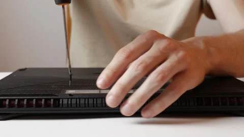 A man repairs a laptop at home Stock Footage 305898008