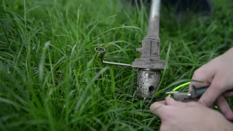 A man repairs a lawn mower to replace spare parts Stock Footage 132873580