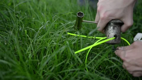 A man repairs a lawn mower to replace spare parts Stock Footage 132873699