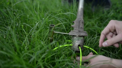A man repairs a lawn mower to replace spare parts Stock Footage 132873788
