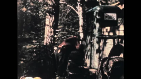 Man repairs an old rusty American pickup truck in a forest in the 1950s Stock Footage 197058279