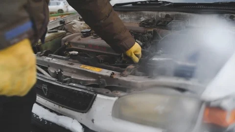 A man repairs an old rusty car Stock Footage 124783761