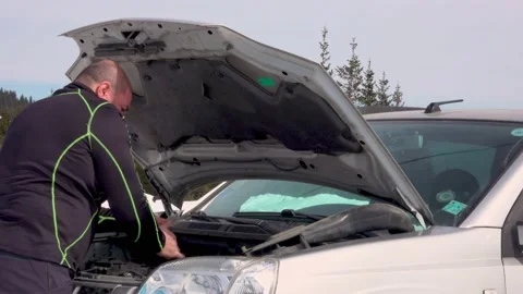Man Repairs Or Fixes Broken Car In Winter Mountains Stock Footage 172111246