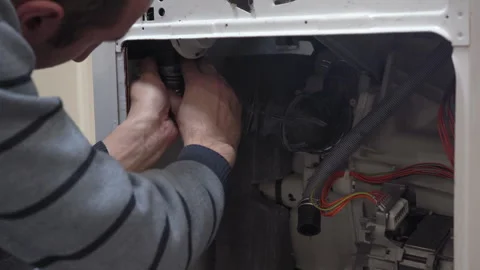 A man repairs a washing machine Video stock 290213284