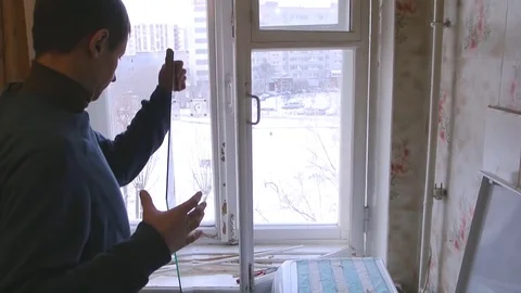 Man repairs wood window. Replace broken glass on window Stock Footage 83267606
