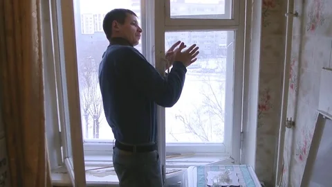 Man repairs wood window. Replace broken glass on window Stock Footage 83268491