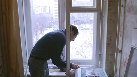 Man repairs wood window. Replace broken glass on window Stock Footage 83269249