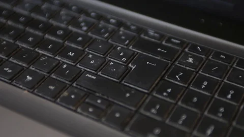 A man repeatedly hits the enter key in frustration. Stock Footage 72775573