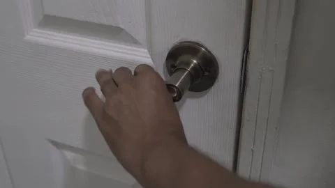 Man repeatedly opening and closing white door at home Stock Footage 320965962