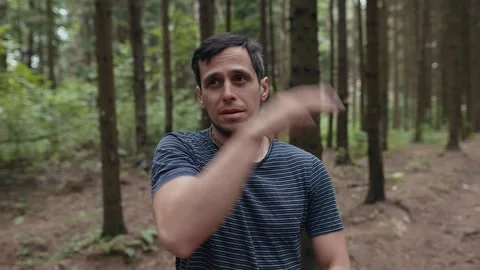 Man repel mosquitoes in the forest Video stock 255714754