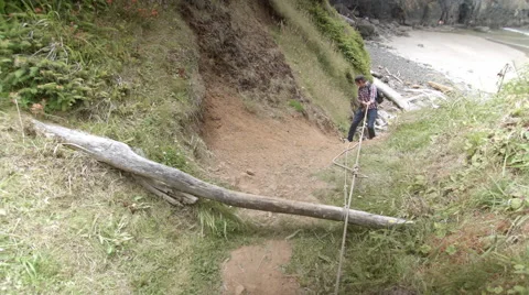 Man Repels Down Sea Cliff In The Pacific Northwest Video stock 48043626