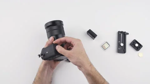 Man replace a battery on a photo video camera with his hand  Stock Footage 138065982