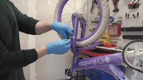 Man replacing brake pads on a bicycle San Francisco CA USA July 15 2025 Stock Footage 313171565