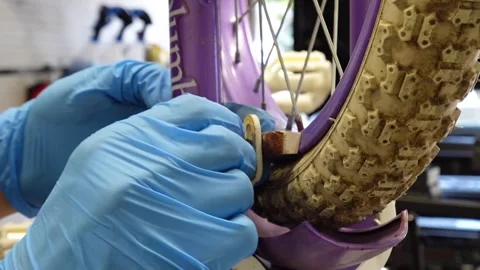 Man replacing brake pads on a bicycle San Francisco CA USA July 15 2025 Stock Footage 313171608