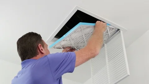 Man Replacing Ceiling Air Filter Stock Footage 90357821