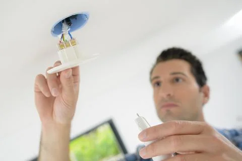 Man is replacing a light switch Stock Photos