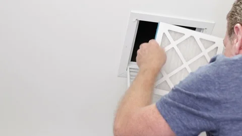Man Replacing a Small Ceiling Air Filter Stock Footage 90357733