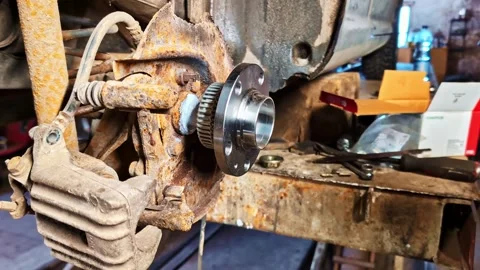 A Man Replacing A Wheel Bearing Assembly. Close-up Shot Stock Footage 333519564