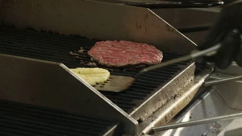 Man Repositioning Pineapple on a Grill Stock Footage 71567373